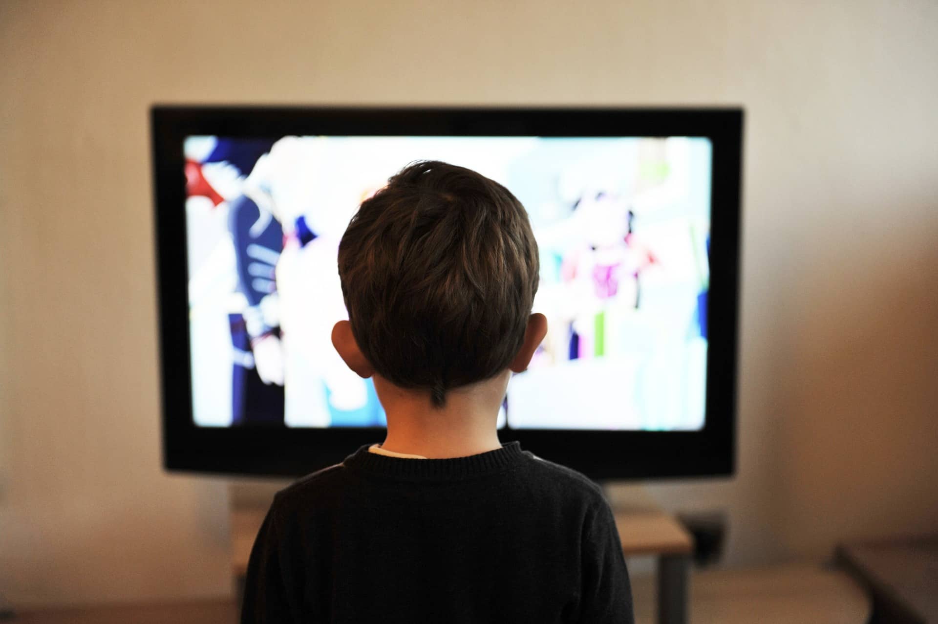 A young boy watching TV